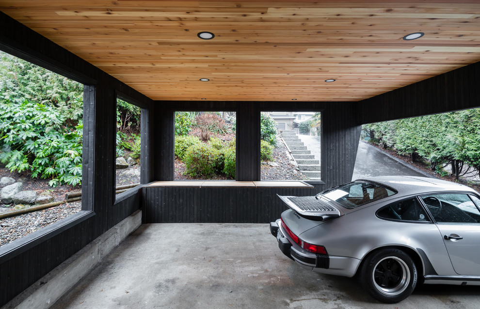 Idée de décoration pour une façade de maison noire design en bois de taille moyenne et à un étage.