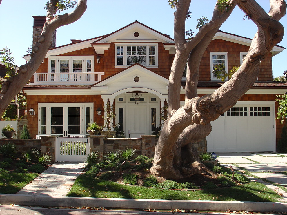 Mid-sized elegant brown two-story mixed siding exterior home photo in Orange County with a shingle roof