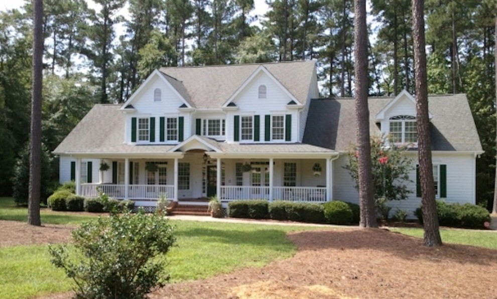 Inspiration for a medium sized and white classic two floor house exterior in Raleigh with vinyl cladding.