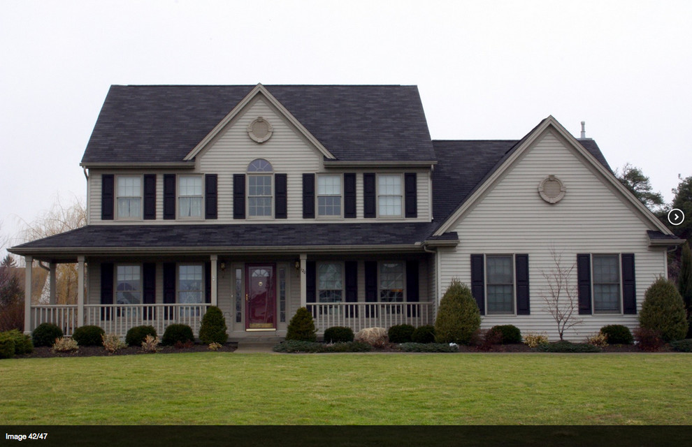 Photo of a medium sized and beige traditional two floor house exterior in Baltimore with vinyl cladding.