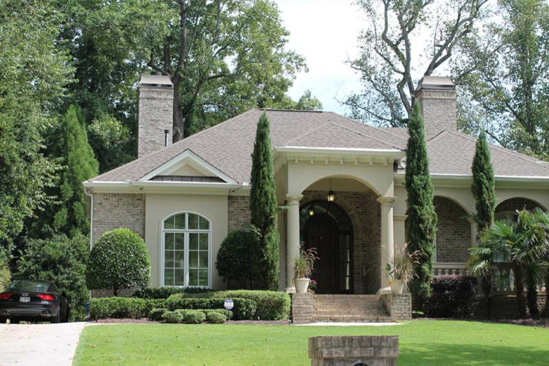 Inspiration for a medium sized and beige mediterranean bungalow brick house exterior in Atlanta.