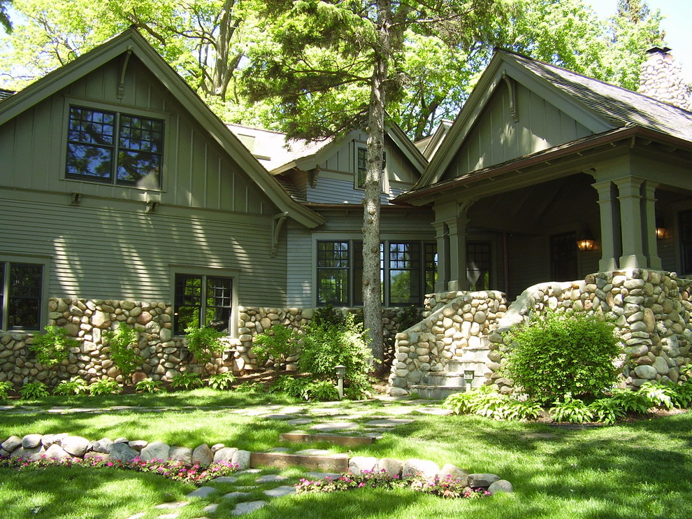 Cette photo montre une grande façade de maison verte montagne à un étage avec un revêtement en vinyle et un toit à deux pans.