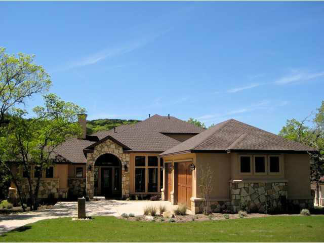 Mid-sized mediterranean black one-story mixed siding gable roof idea in Austin