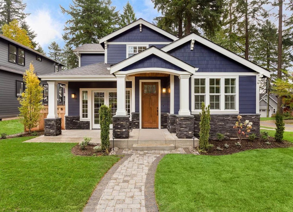 Стильный дизайн: двухэтажный, синий частный загородный дом среднего размера в классическом стиле с крышей из гибкой черепицы, комбинированной облицовкой и вальмовой крышей - последний тренд