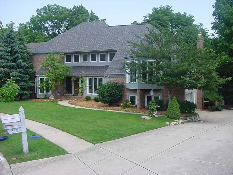 Design ideas for a large and red classic two floor brick house exterior in Columbus.
