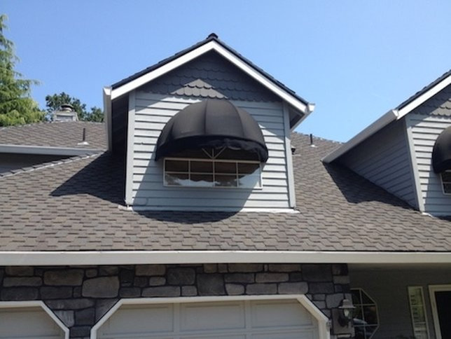 Large transitional gray two-story wood house exterior idea in Portland with a hip roof and a shingle roof