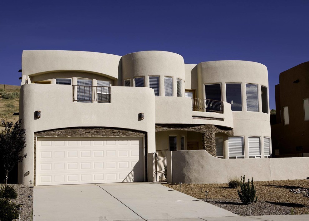 Photo of a large and white classic two floor clay house exterior in Albuquerque with a flat roof.