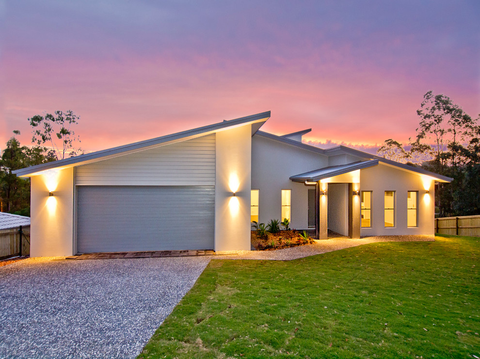 Design ideas for a white modern split-level brick house exterior in Brisbane.