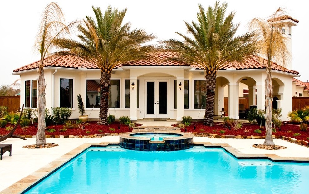 Inspiration for a mid-sized mediterranean white one-story stucco house exterior remodel in Houston with a hip roof and a tile roof