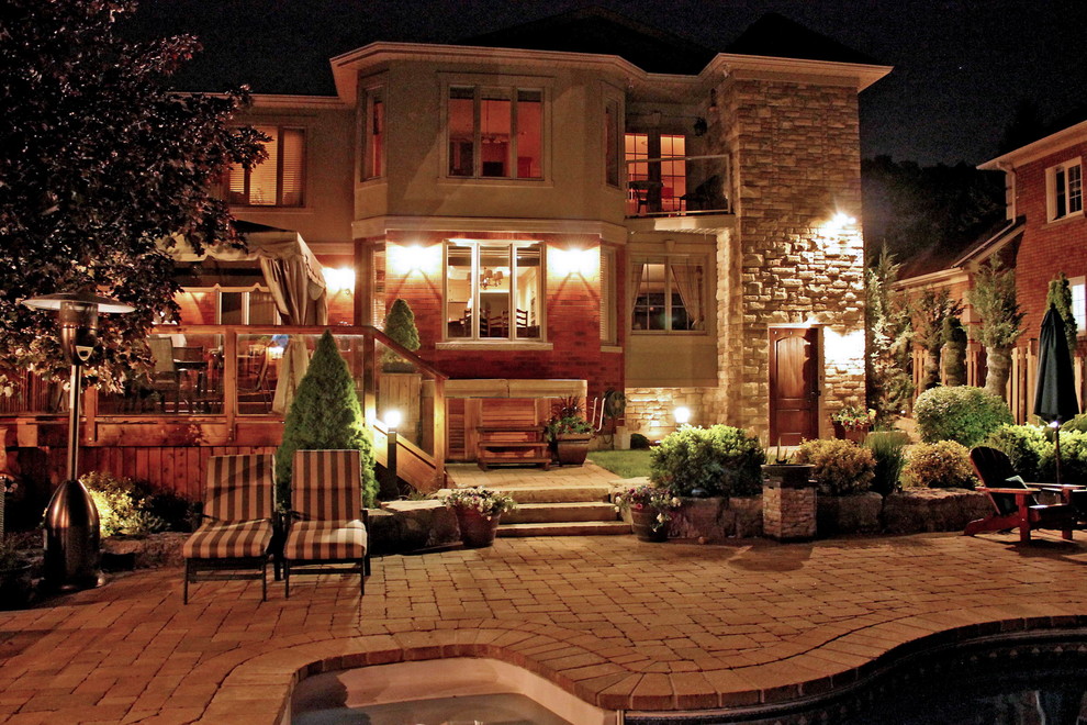 Example of a large classic beige two-story stone exterior home design in Toronto