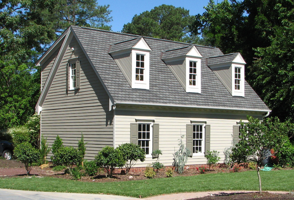 Example of a mid-sized transitional beige two-story vinyl gable roof design in Raleigh