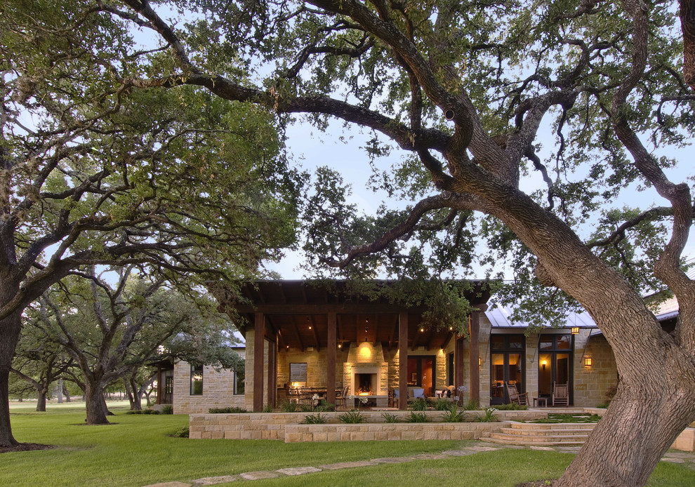 Inspiration for a large contemporary one-story stone gable roof remodel in Austin