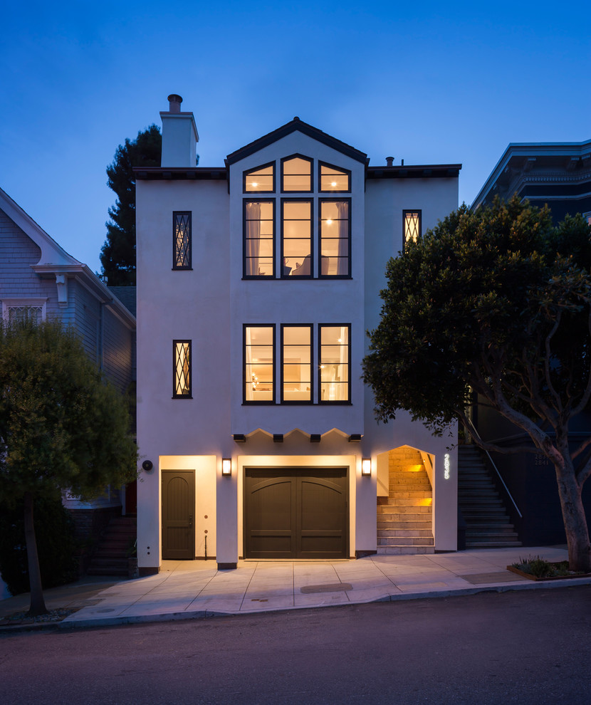 Example of a huge minimalist beige three-story stucco gable roof design in San Francisco