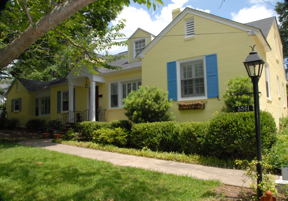 Стильный дизайн: двухэтажный, кирпичный, желтый дом среднего размера в классическом стиле с двускатной крышей - последний тренд
