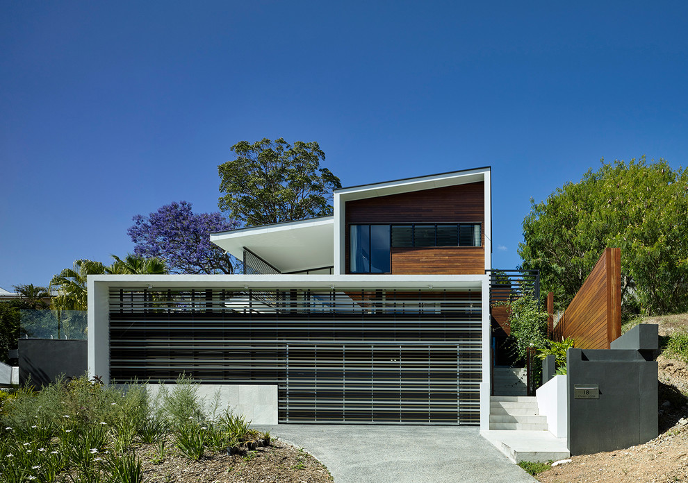 Inspiration for a large and white contemporary two floor house exterior in Brisbane with mixed cladding and a lean-to roof.