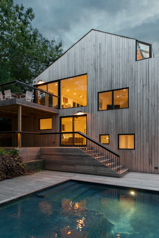 Mid-sized trendy split-level wood exterior home photo in New York with a shingle roof
