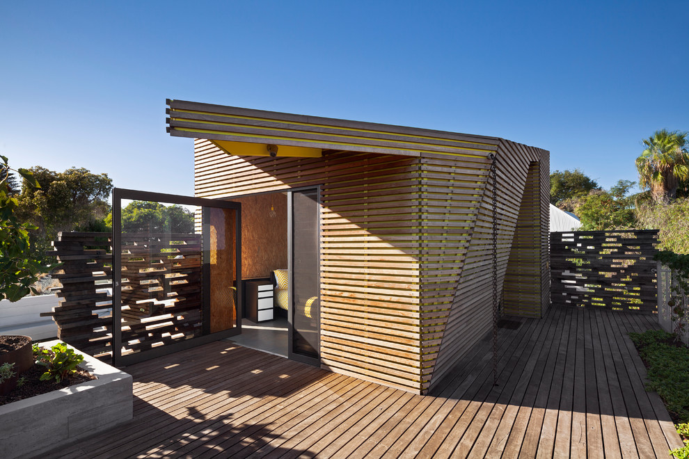 Inspiration for a brown contemporary house exterior in Perth with wood cladding and a flat roof.