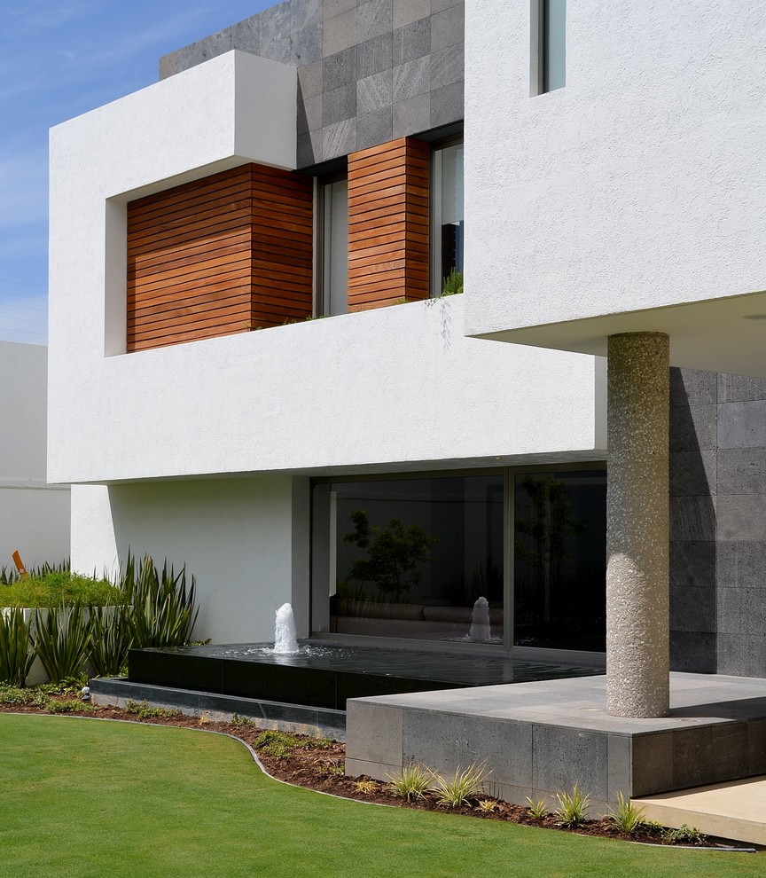 This is an example of a contemporary house exterior in Other with stone cladding.