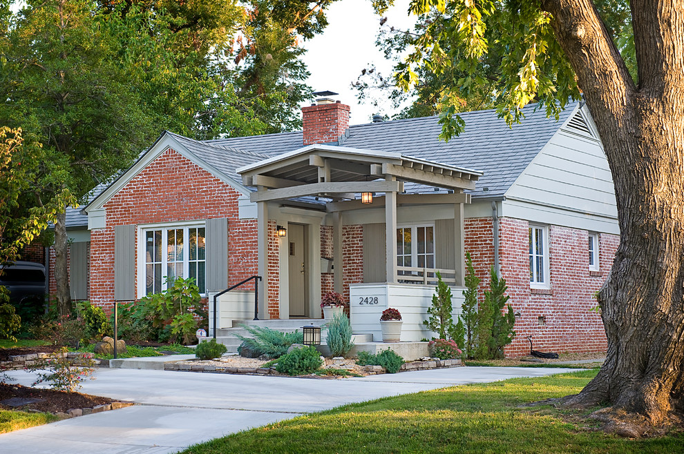 This is an example of a medium sized and red traditional bungalow brick house exterior in Other.
