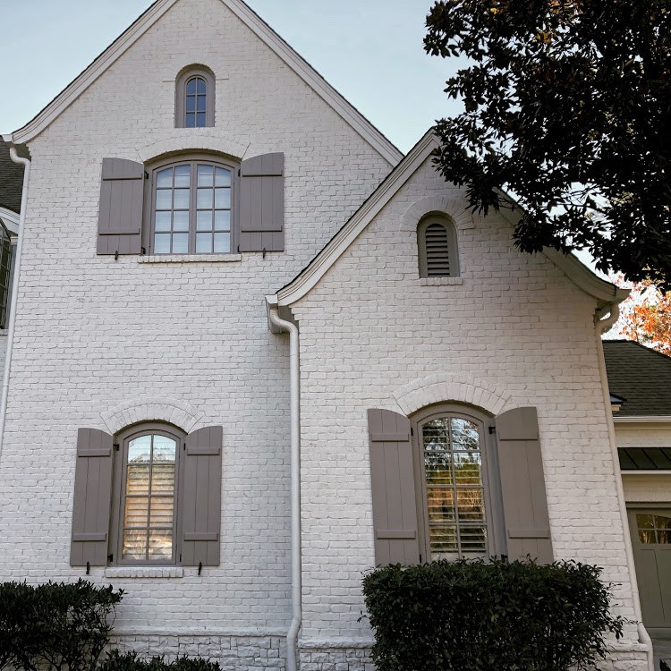 Photo of a large and white classic brick detached house in Atlanta with three floors, a pitched roof and a shingle roof.