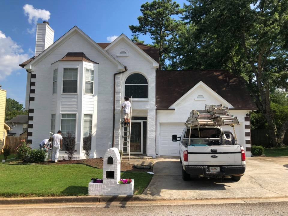 This is an example of a medium sized and white classic two floor brick detached house in Atlanta with a pitched roof and a shingle roof.