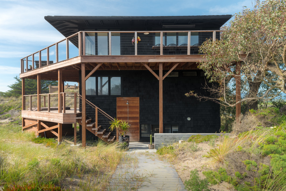 Inspiration for a mid-sized coastal black three-story wood house exterior remodel in Other