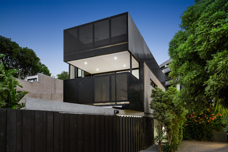 Photo of a contemporary house exterior in Melbourne with three floors and a flat roof.