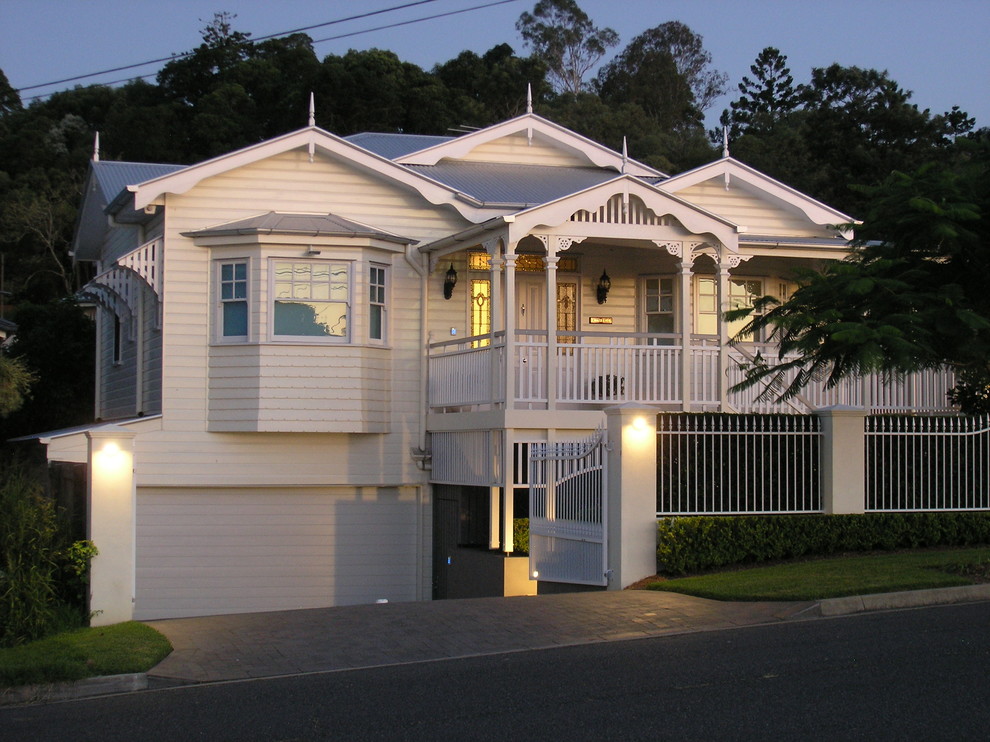 Large and yellow classic two floor house exterior in Brisbane with wood cladding.