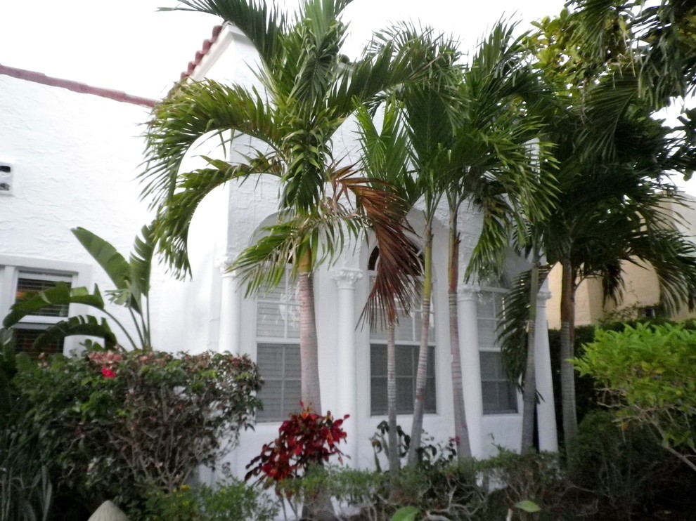 Design ideas for a white mediterranean bungalow render house exterior in Miami.