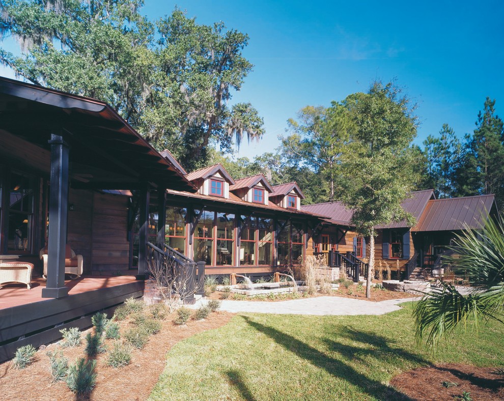 Photo of an expansive classic bungalow house exterior in Atlanta with wood cladding.