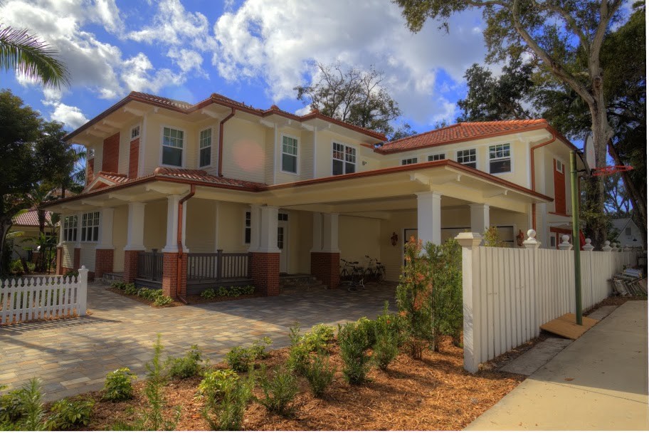 Example of a large classic yellow two-story wood exterior home design in Tampa with a hip roof
