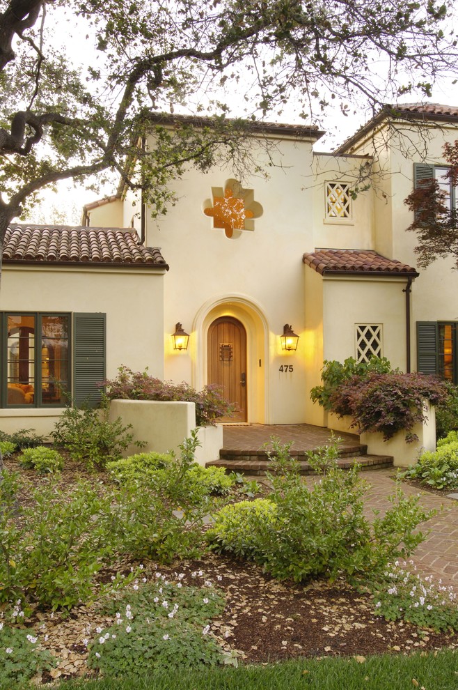 Inspiration for a mediterranean two-story stucco exterior home remodel in San Francisco with a tile roof