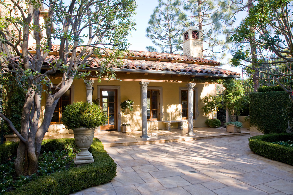 Photo of a mediterranean bungalow house exterior in Los Angeles with a tiled roof.
