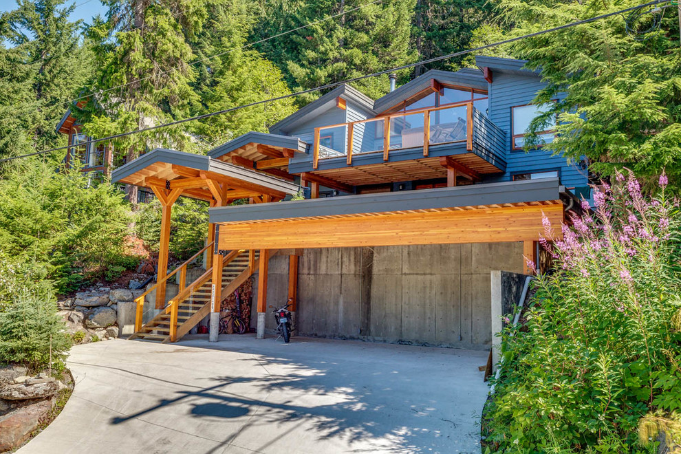 Inspiration for a blue three-story wood house exterior remodel in Vancouver
