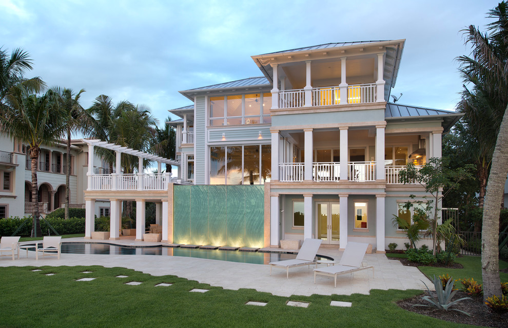 Blue beach style house exterior in Miami with three floors.