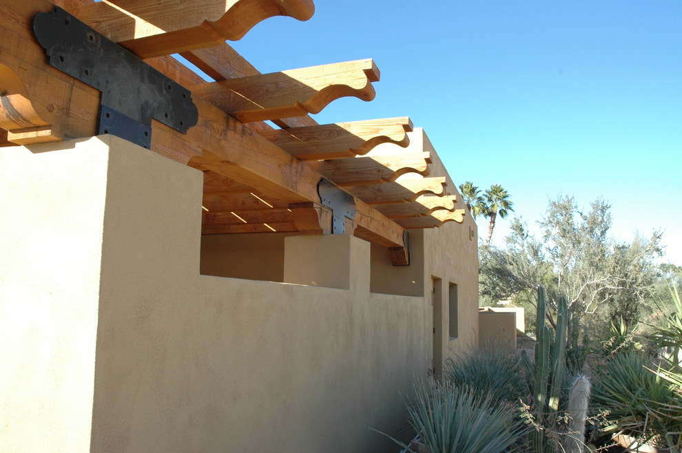 Inspiration for a large southwestern beige one-story adobe exterior home remodel in Phoenix