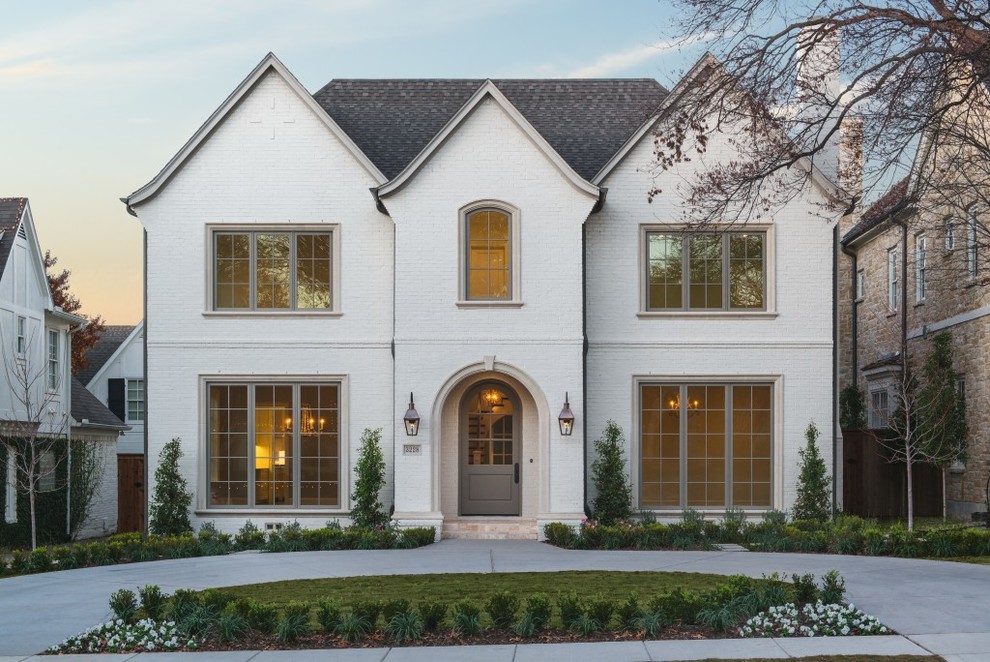 Inspiration for a timeless white two-story brick gable roof remodel in Dallas