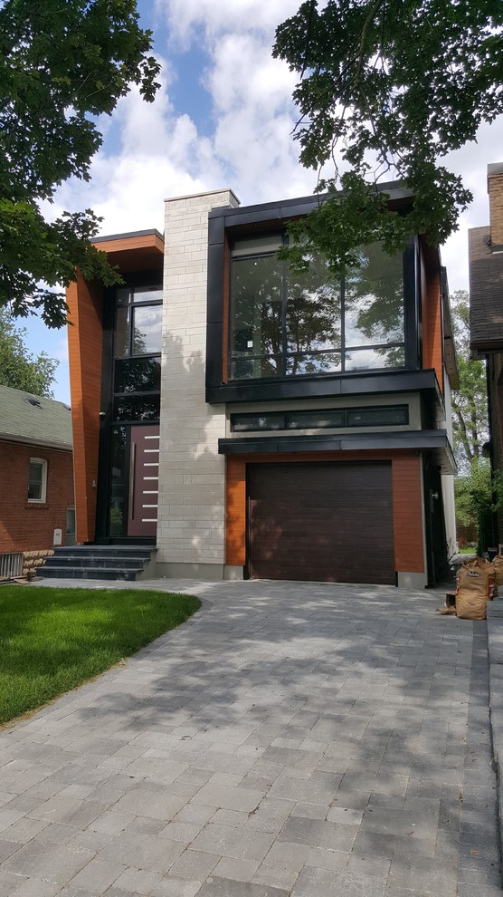 Design ideas for a modern two floor detached house in Toronto with a flat roof.