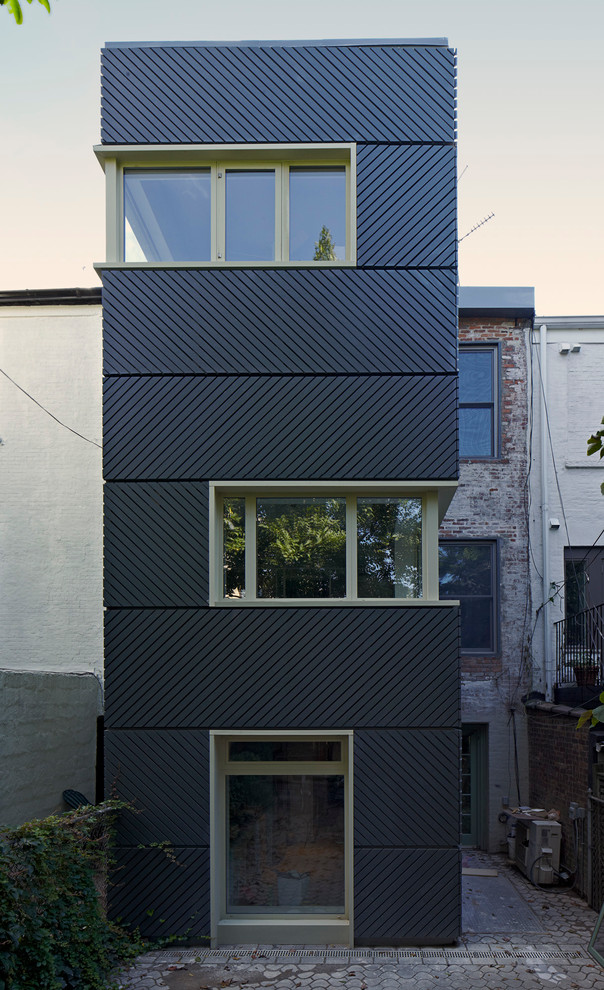 Modelo de fachada gris minimalista de tres plantas con revestimiento de aglomerado de cemento