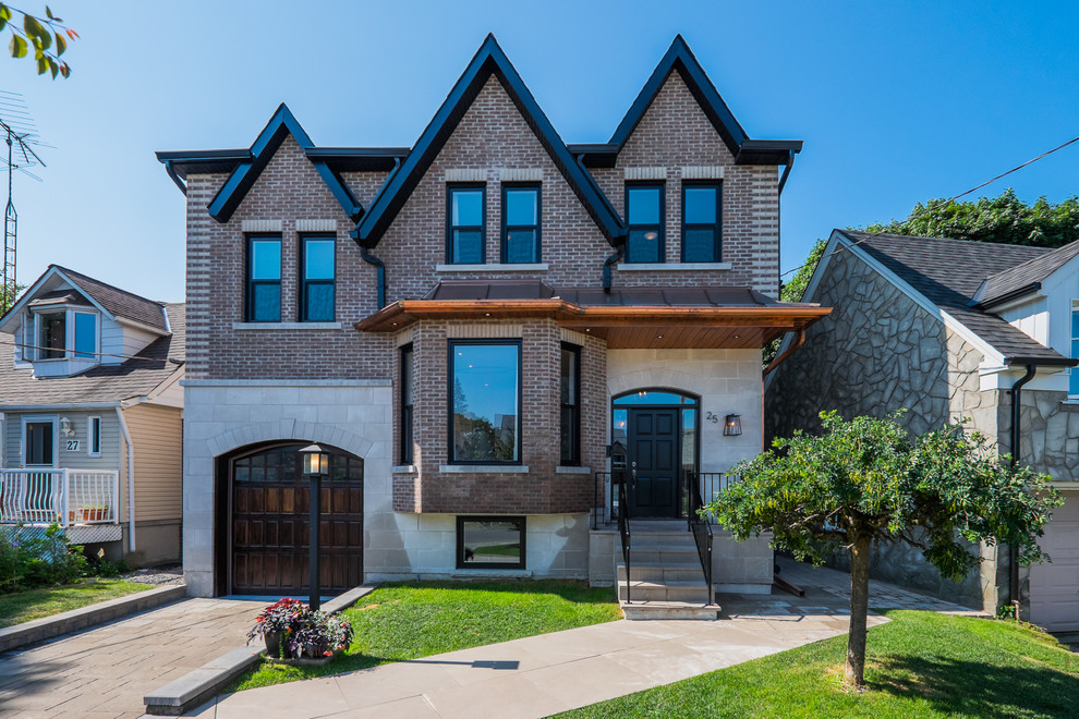Inspiration for a large timeless beige two-story brick gable roof remodel in Toronto