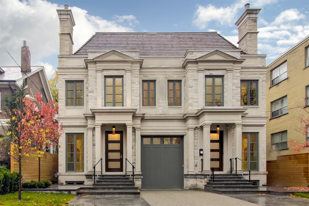 Traditional two-story stone duplex exterior idea in Toronto with a hip roof