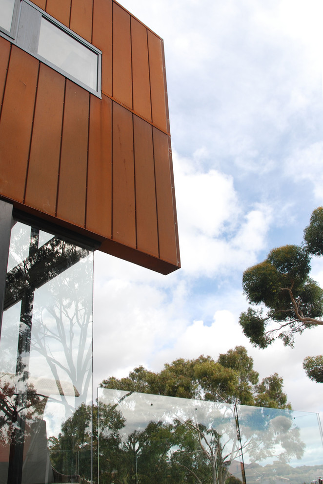 Photo of a large and brown contemporary two floor detached house in Adelaide with metal cladding, a lean-to roof and a metal roof.