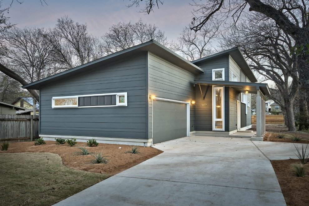 This is an example of a small contemporary bungalow house exterior in Austin with mixed cladding and a lean-to roof.
