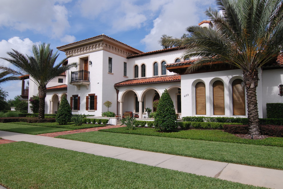 Inspiration for a white mediterranean two floor house exterior in Orlando.
