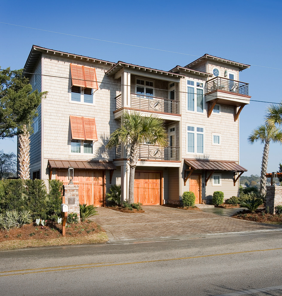 Design ideas for a gey coastal house exterior in Charleston with three floors and wood cladding.