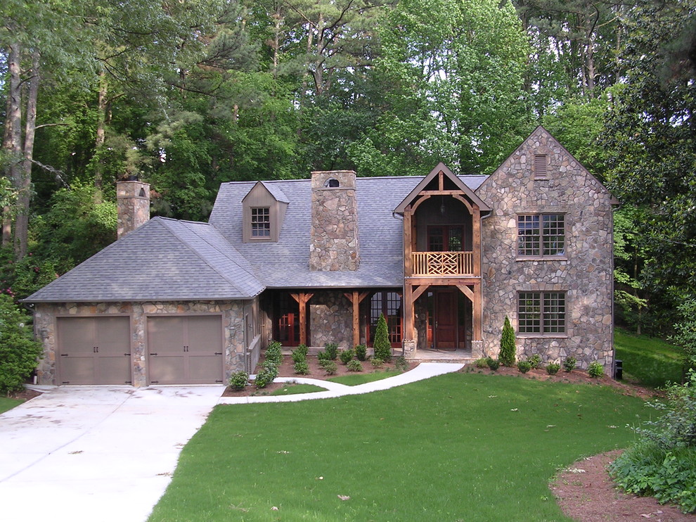 Design ideas for a rustic house exterior in Atlanta with stone cladding.