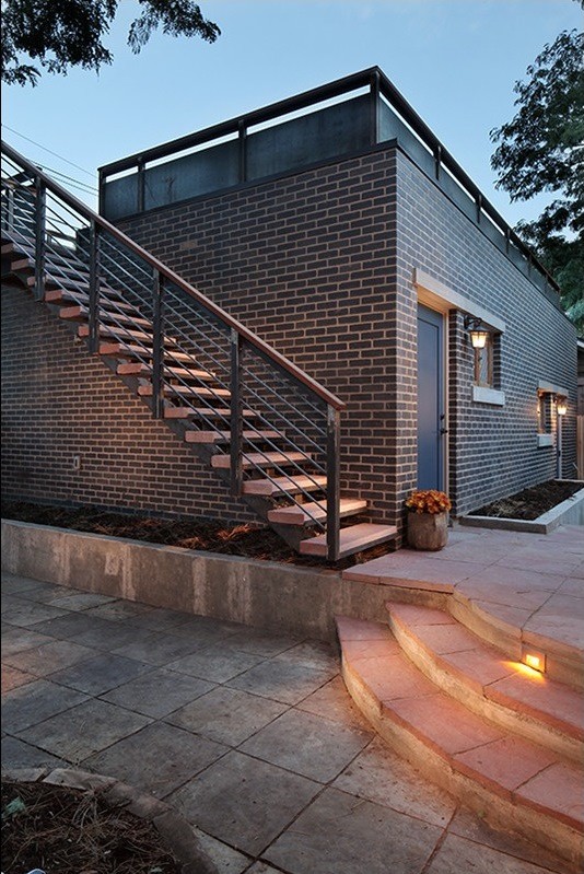 Imagen de fachada negra minimalista de tamaño medio de una planta con revestimiento de ladrillo y tejado plano