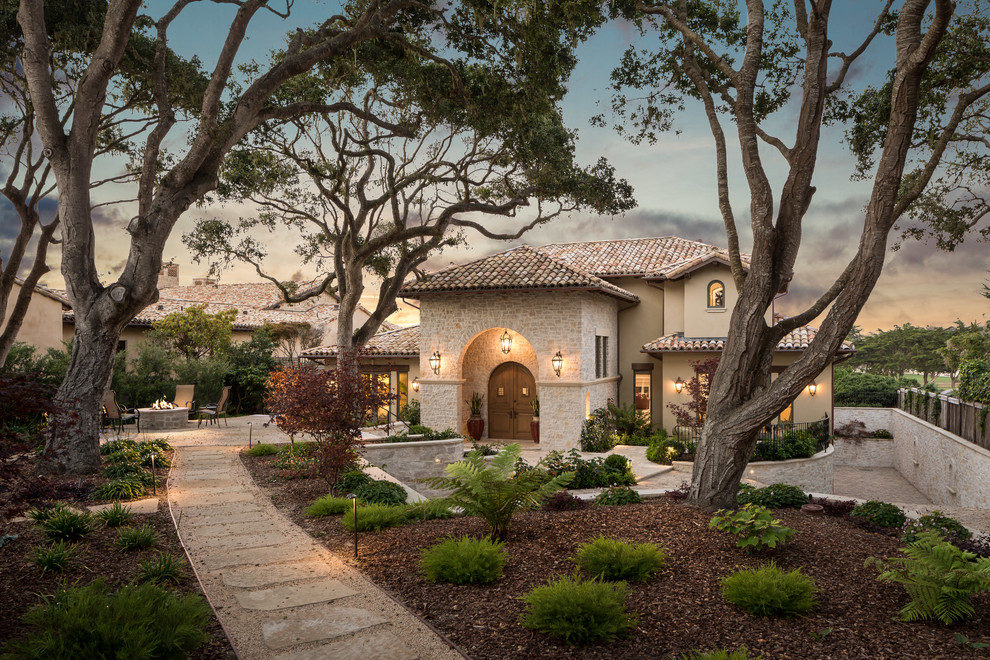 Large tuscan beige three-story stone exterior home photo in San Francisco with a tile roof