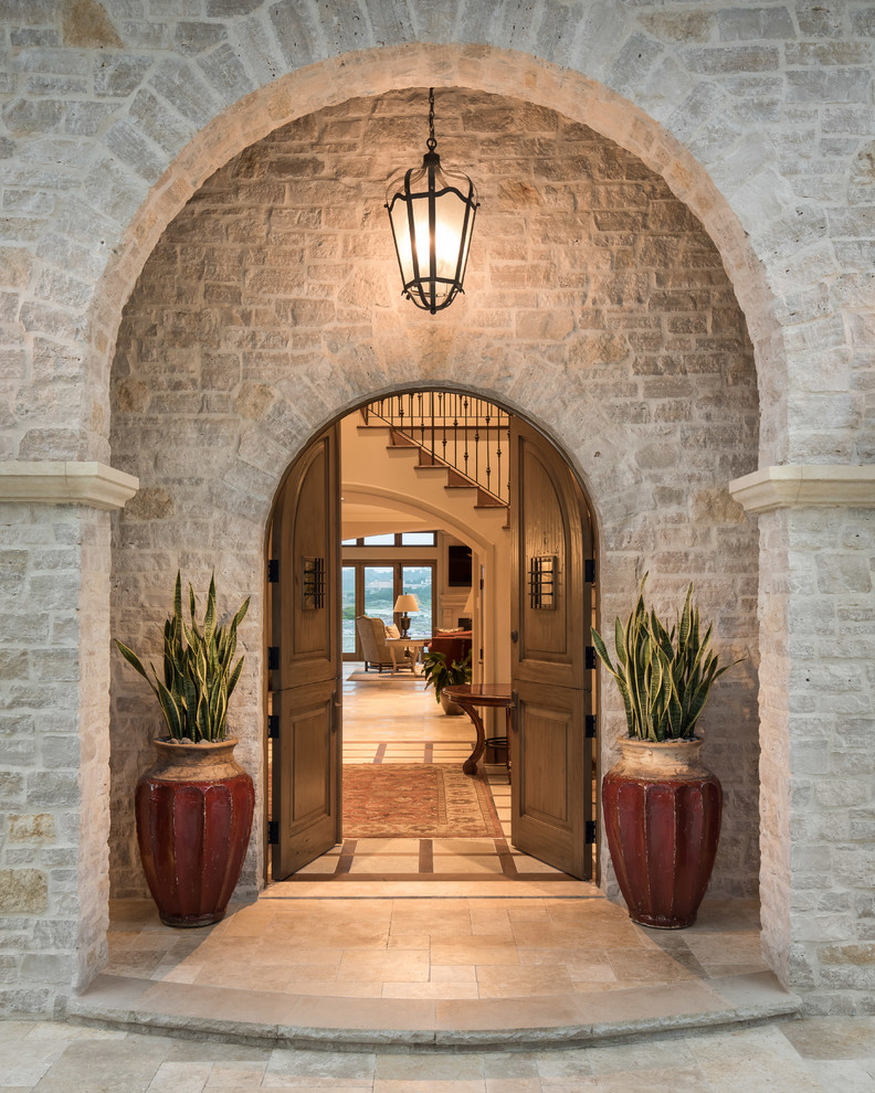 Design ideas for a large and beige mediterranean detached house in San Francisco with three floors, stone cladding, a pitched roof and a tiled roof.