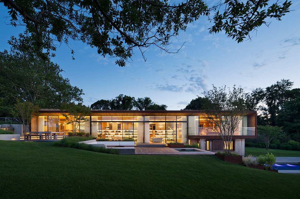 Inspiration for a large contemporary one-story glass exterior home remodel in New York